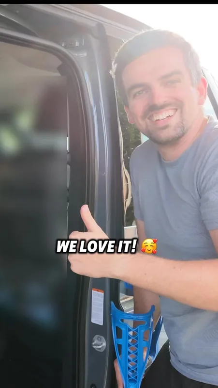 Video cover: a smiling man holding a blue crutch gives a thumbs-up at the open van door, text “WE LOVE IT!”.